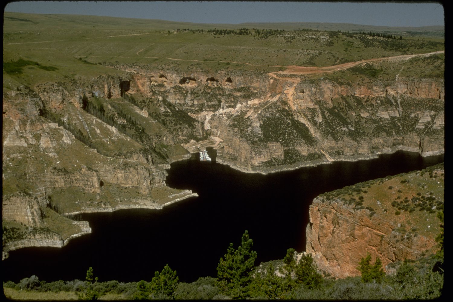 Bighorn Lake filling the bottom of the canyon between tall rock walls.
